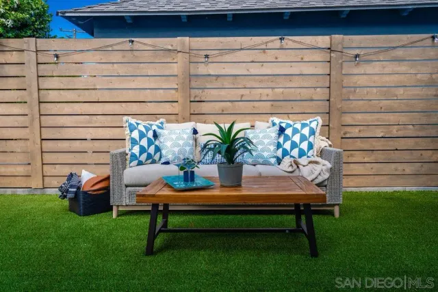 a living room with furniture plant and a window
