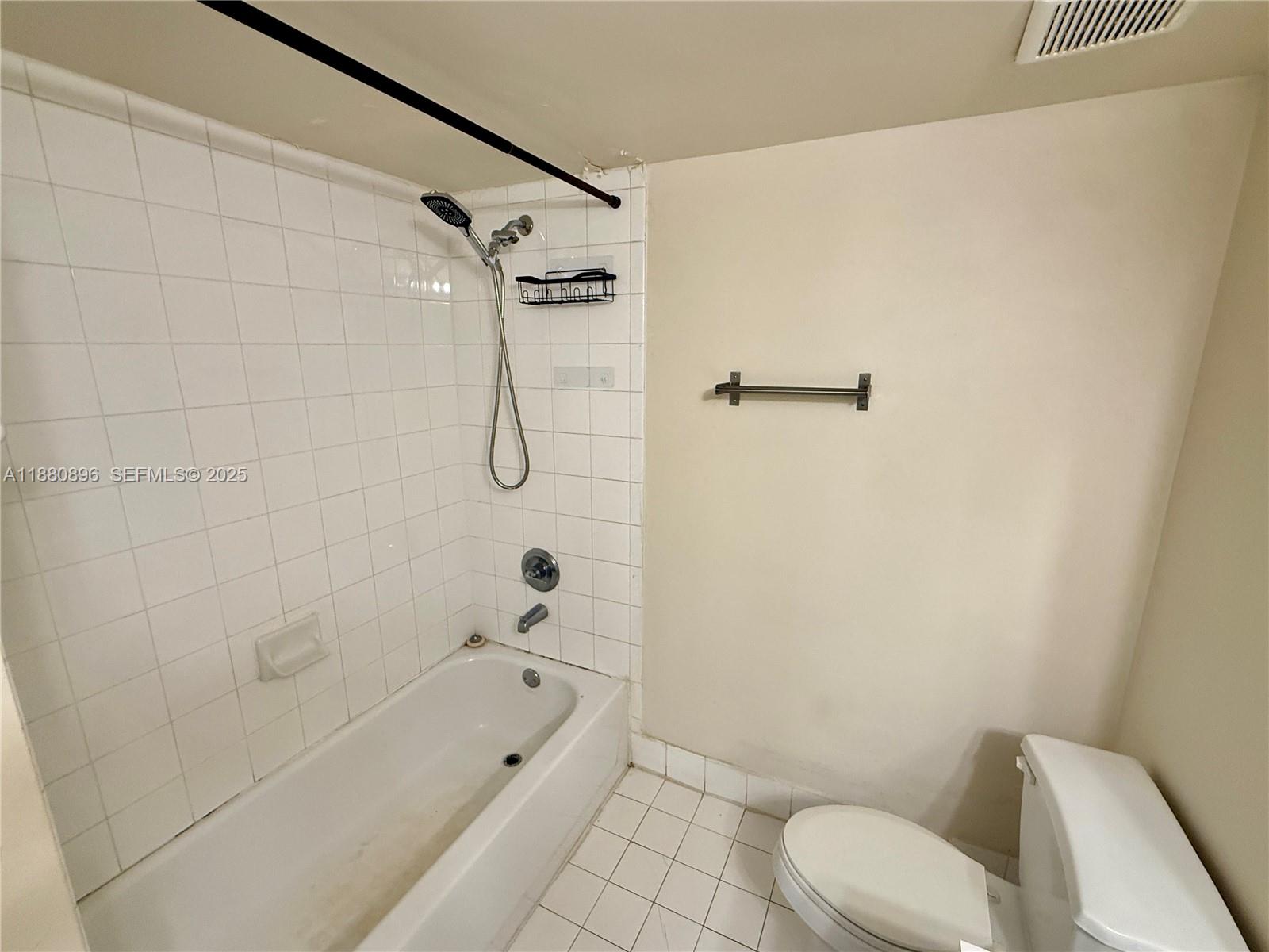 3870 Lyons Road, Unit 2108 Coconut Creek, FL 33073 - Photo 15 of 19 a bathroom with a shower a toilet and a bath tub