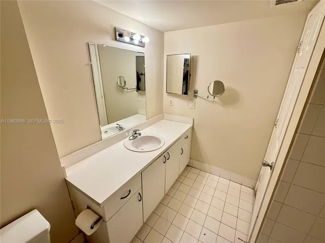 a bathroom with a sink a toilet and mirror