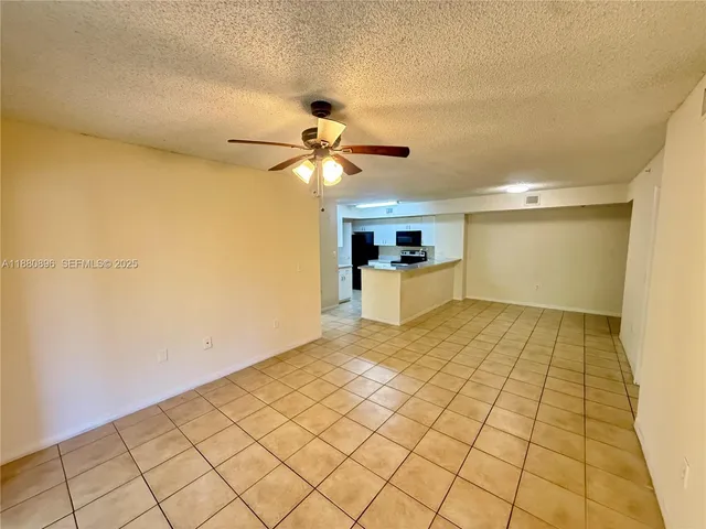 a view of a room with a wooden floor and white walls