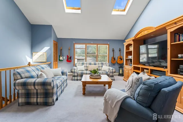 a living room with furniture a large window and outer view