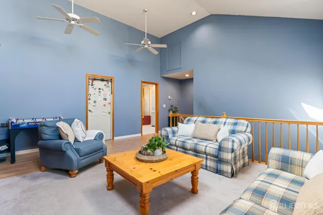 a living room with furniture and a chandelier
