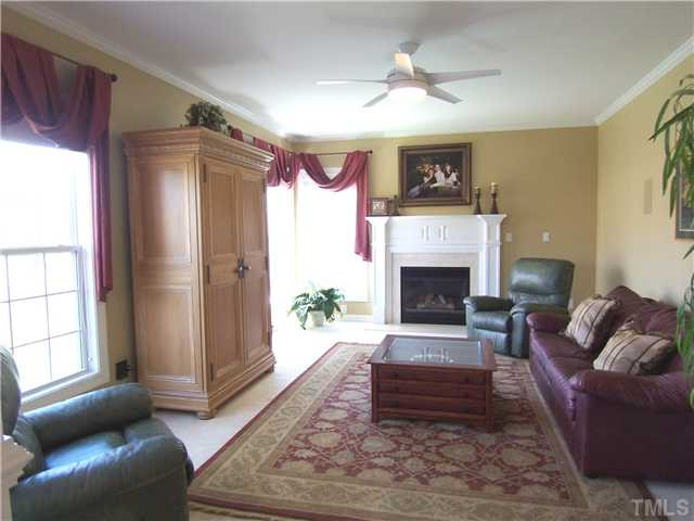 1805 Wescott Drive Raleigh, NC 27614 - Photo 5 of 12 Open to the KIT over a half wall is spacious Family Rm w/gas log FP, CF & neutral carpet. Nearby is Laundry/Mud Rm w/cabinets which leads to the oversized 2-car Garage & pretty Half-Bath w/pedestal sink. Den/Family/Great Room