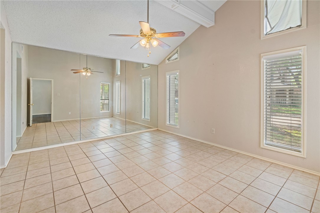 7209 Candy Ridge Road Corpus Christi, TX 78413 - Photo 19 of 24 an empty room & chandelier fan and windows