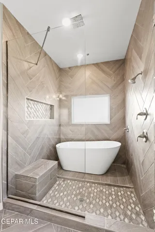 a bathroom with a bathtub and shower
