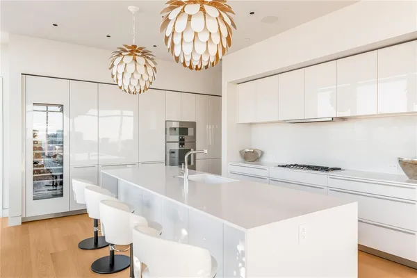 a kitchen with a sink and a chandelier