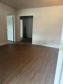 an empty room with wooden floor