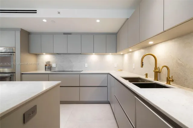 a kitchen with a sink cabinets and stainless steel appliances
