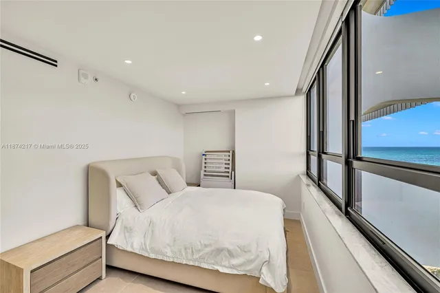 a bedroom with a bed and a large window