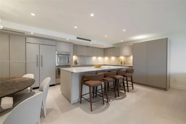 a kitchen with a table and chairs in it