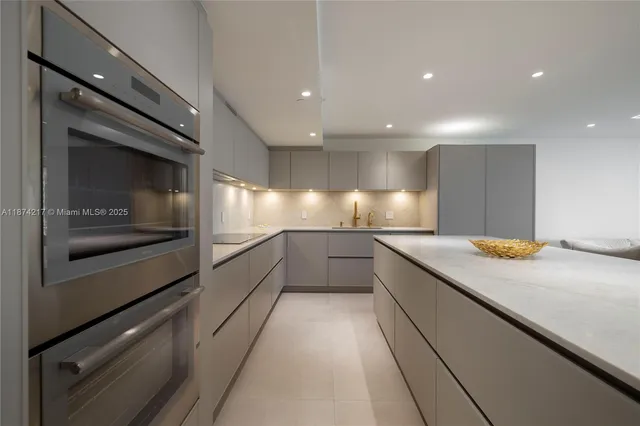 a kitchen with a sink and stainless steel appliances