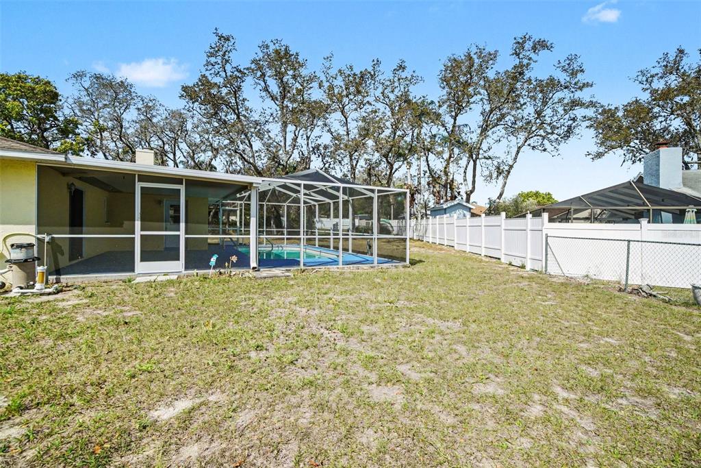 113 Ruskin Avenue Spring Hill, FL 34606 - Photo 28 of 32 a view of a house with a backyard and a garden