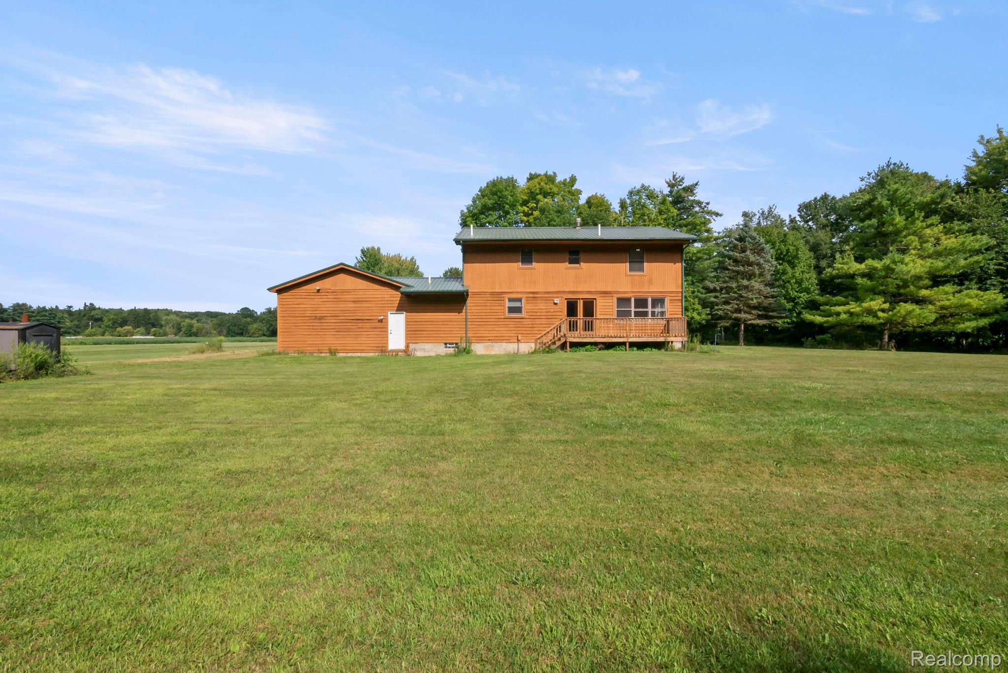 76565 McFadden Road Armada, MI 48005 - Photo 52 of 95 Wood-sided exterior with a green metal roof