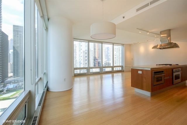 340 East Randolph Street, Unit 1606 Chicago, IL 60601 - Photo 7 of 29 a view of a kitchen with a sink and a large window