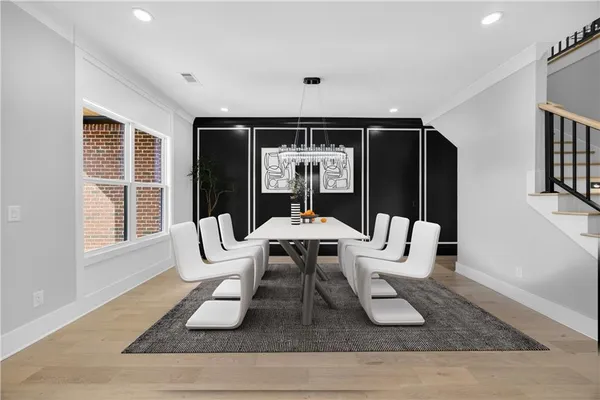 a kitchen with stainless steel appliances granite countertop white cabinets and refrigerator