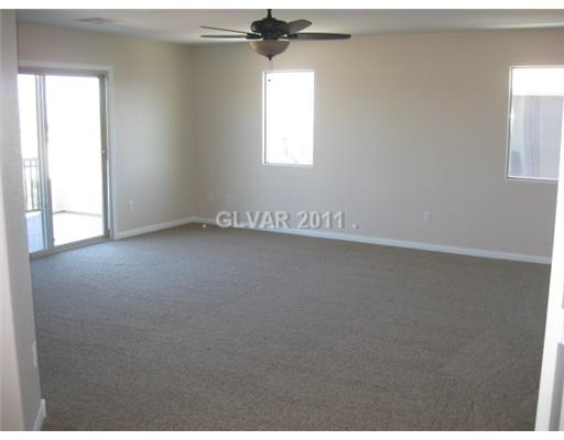 124 Turtle Ridge Avenue Las Vegas, NV 89183 - Photo 11 of 21 Master Bedroom. Master w/ceiling fan & balcony with strip, city & mountain view