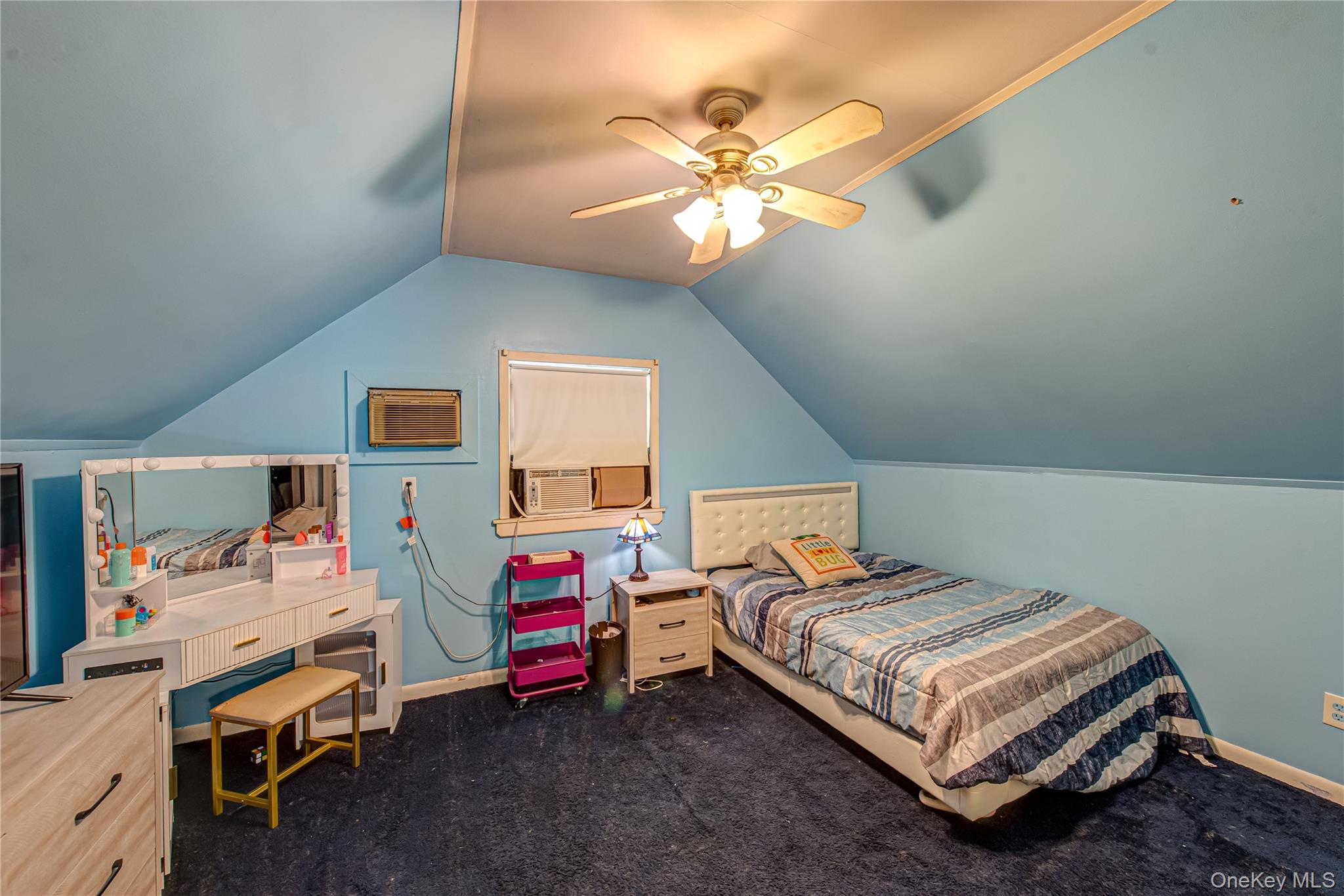 137 Wood Road Centereach, NY 11720 - Photo 11 of 16 a bedroom with a bed and a chandelier