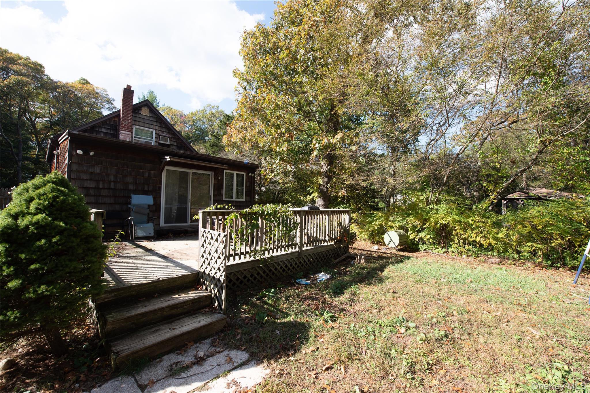 137 Wood Road Centereach, NY 11720 - Photo 14 of 16 a view of a deck with wooden floor and outdoor seating