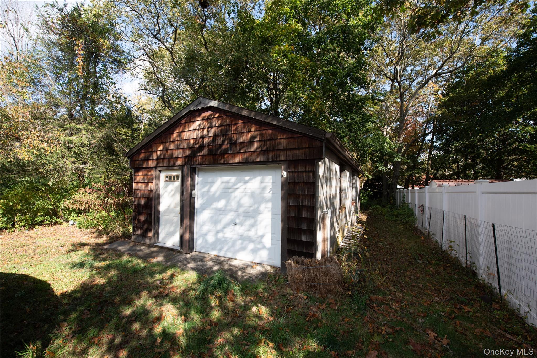 137 Wood Road Centereach, NY 11720 - Photo 15 of 16 a backyard of a house with lots of green space