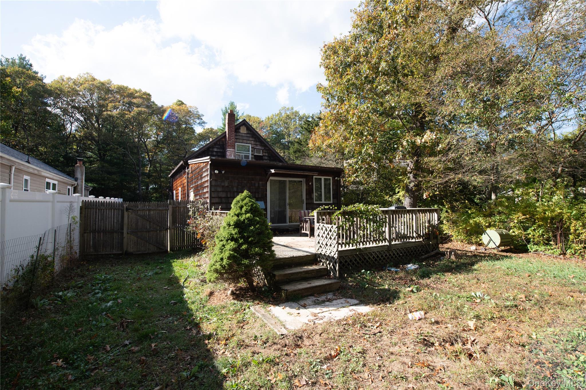 137 Wood Road Centereach, NY 11720 - Photo 16 of 16 a front view of a house with a yard and garage
