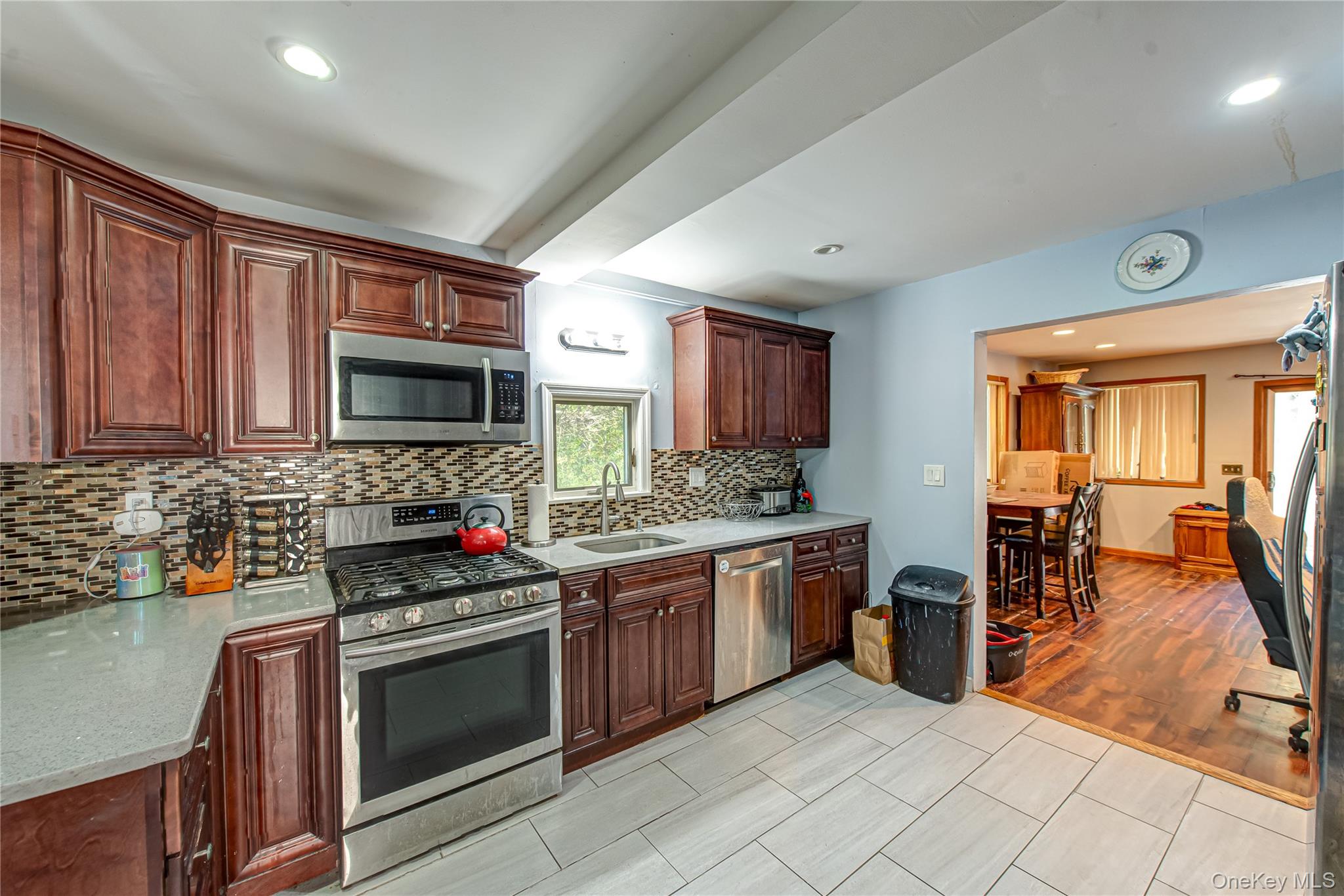 137 Wood Road Centereach, NY 11720 - Photo 5 of 16 a kitchen with stainless steel appliances granite countertop a stove top oven microwave and cabinets