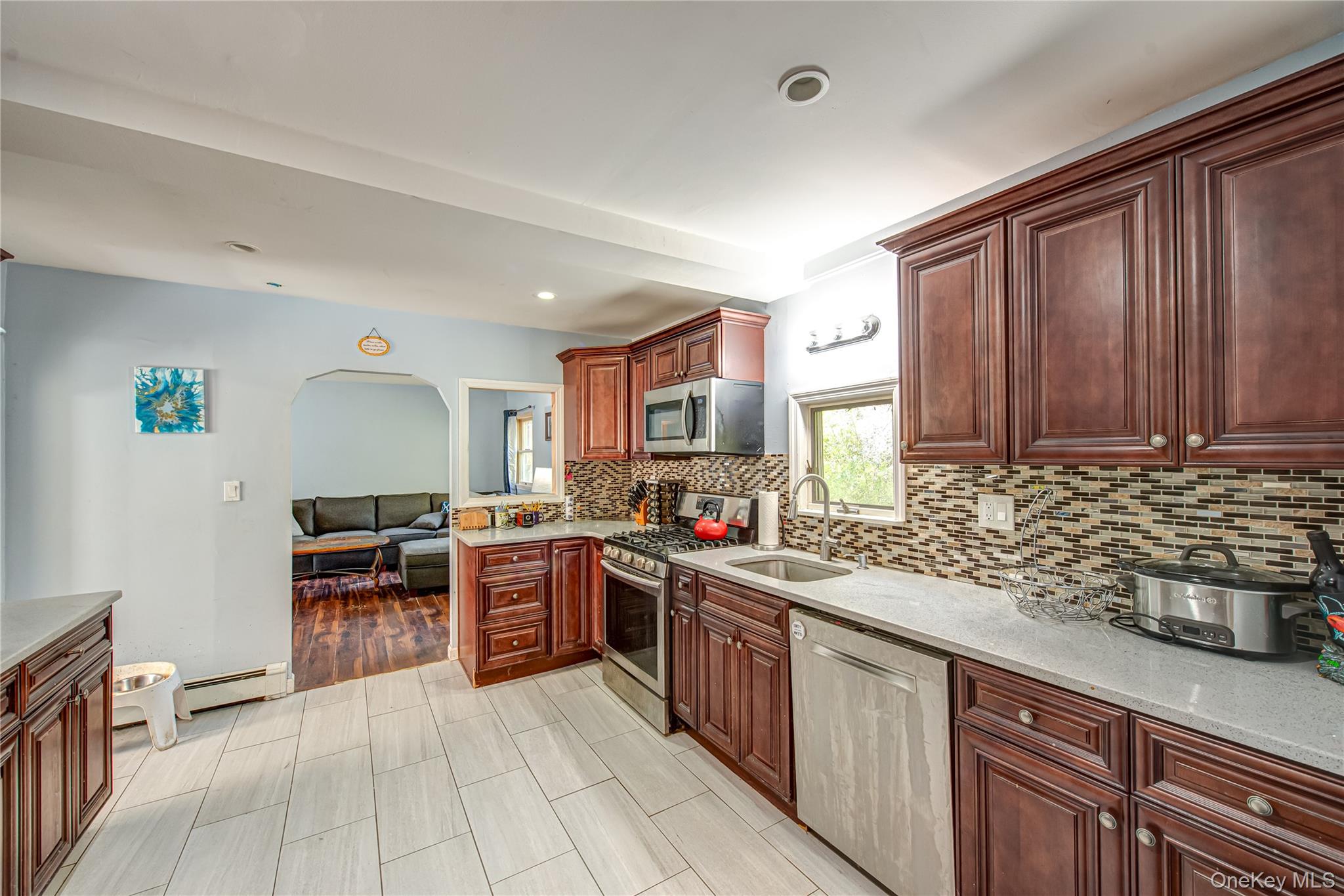137 Wood Road Centereach, NY 11720 - Photo 6 of 16 a kitchen with stainless steel appliances granite countertop wooden cabinets a stove top oven a sink and dishwasher