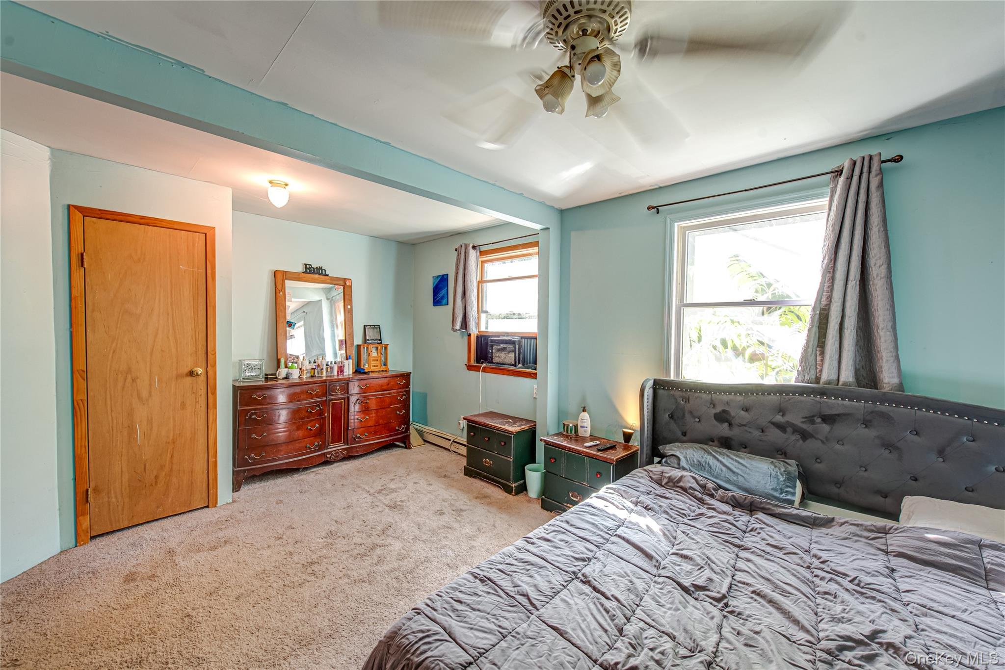 137 Wood Road Centereach, NY 11720 - Photo 9 of 16 a spacious bedroom with a large bed and a window