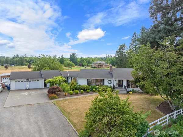a aerial view of a house with a yard and potted plants
