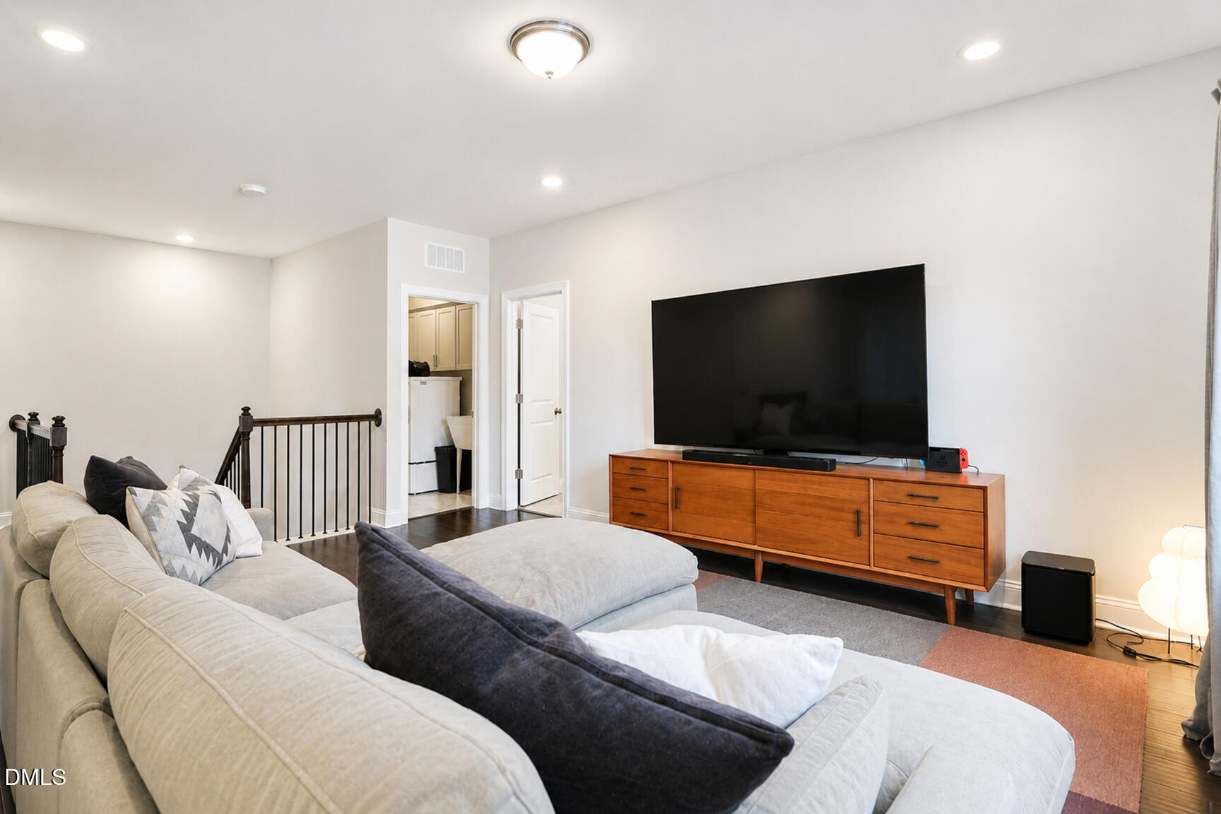 2966 Rise And Shine Road Apex, NC 27502 - Photo 27 of 61 a living room with furniture and a flat screen tv