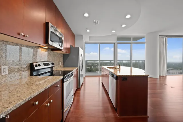 a kitchen with stainless steel appliances granite countertop a stove and a sink