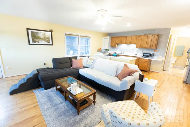 a living room with furniture and a wooden floor