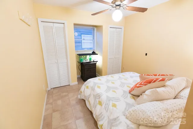 a bed sitting in a bedroom next to a window