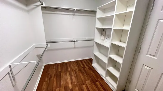a view of walk in closet with empty racks