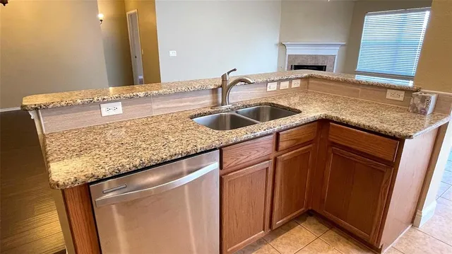 a kitchen with granite countertop sink and cabinets