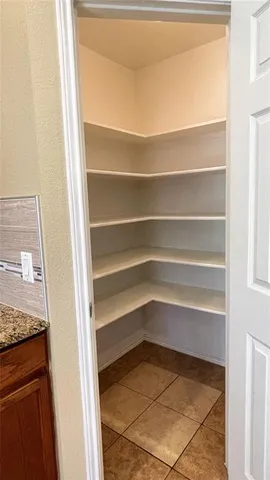 a refrigerator view with a wooden floor
