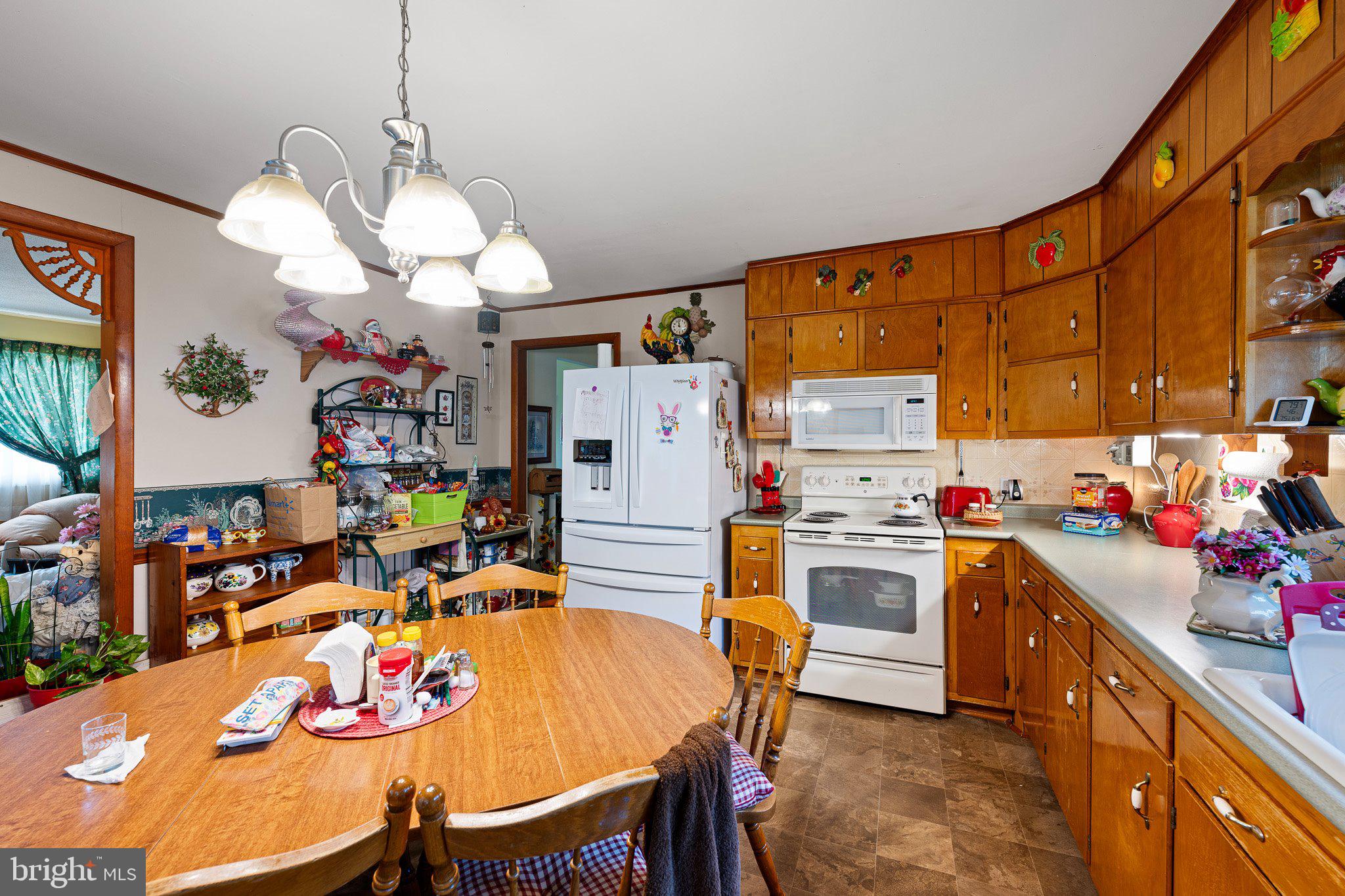 3302 Barratts Chapel Road Frederica, DE 19946 - Photo 11 of 19 a kitchen with kitchen island a dining table and chairs