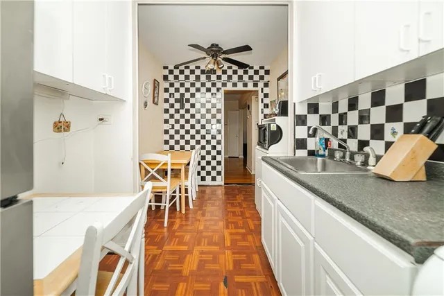 a kitchen with granite countertop sink and cabinets