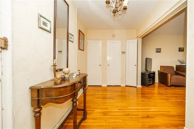 a room with table chairs and wooden floor