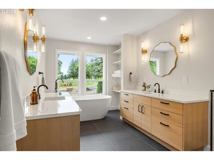 a bathroom with a double vanity sink and a mirror
