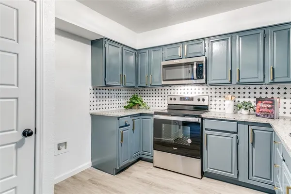 a kitchen with stainless steel appliances granite countertop a sink and stove top oven