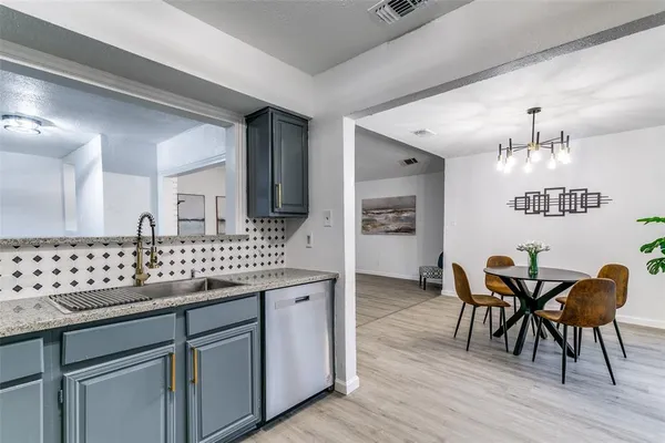a view of dining table chairs and wooden floor