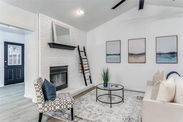 a living room with furniture a rug and a fireplace