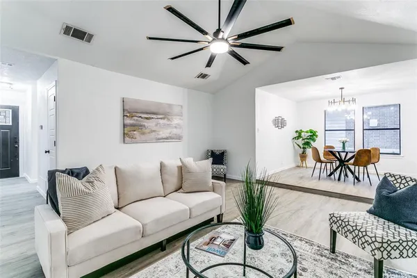a living room with furniture and a chandelier