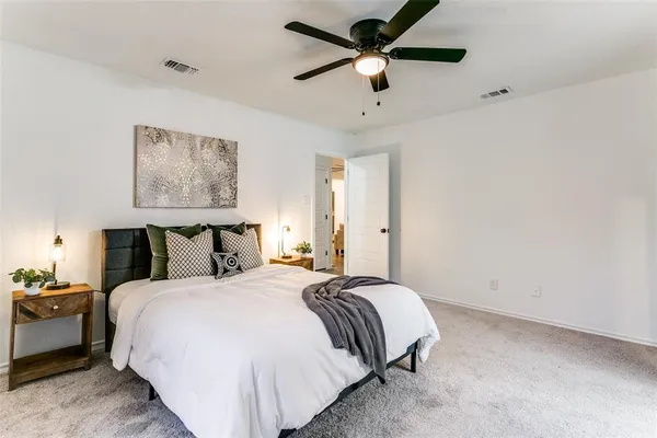 a bedroom with bed and a chandelier