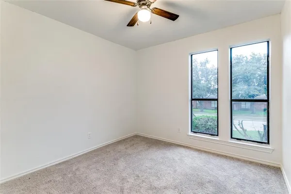an empty room with windows and closet