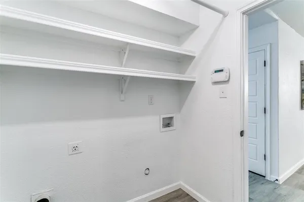 a backyard of a house with large trees and wooden fence