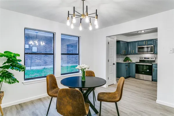 a kitchen with furniture wooden floor and kitchen view