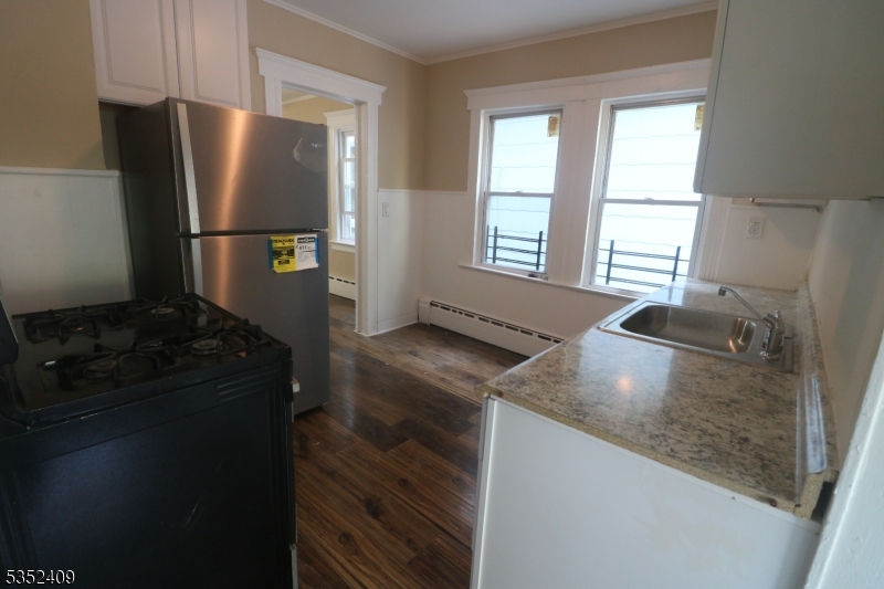 40 Mitchell Street West Orange, NJ 07052 - Photo 11 of 17 a kitchen with a refrigerator and a stove