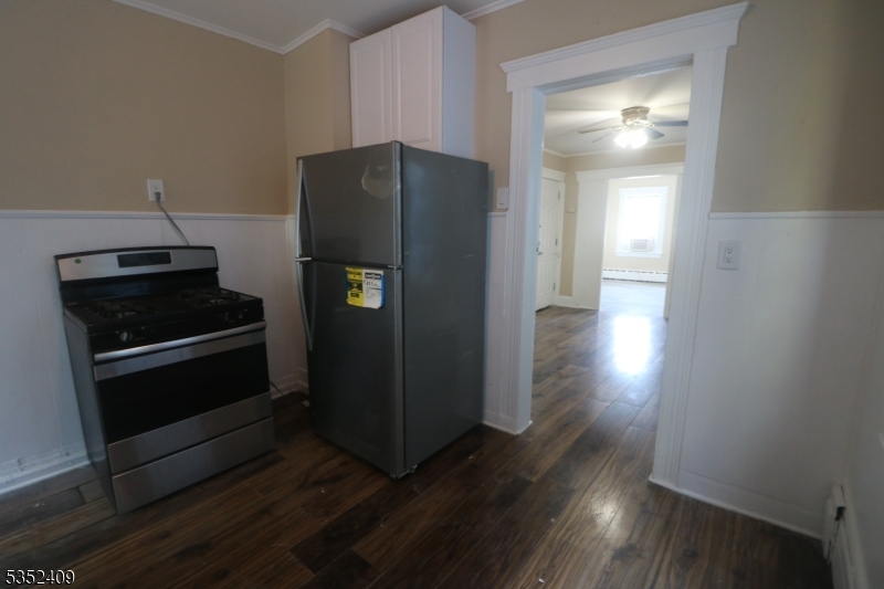 40 Mitchell Street West Orange, NJ 07052 - Photo 12 of 17 a kitchen with granite countertop a refrigerator and a stove top oven