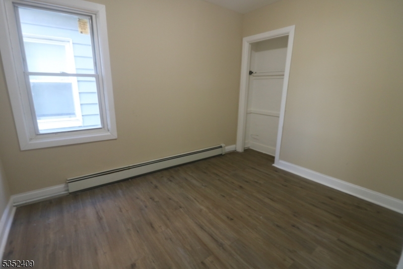 40 Mitchell Street West Orange, NJ 07052 - Photo 13 of 17 an empty room with wooden floor and windows